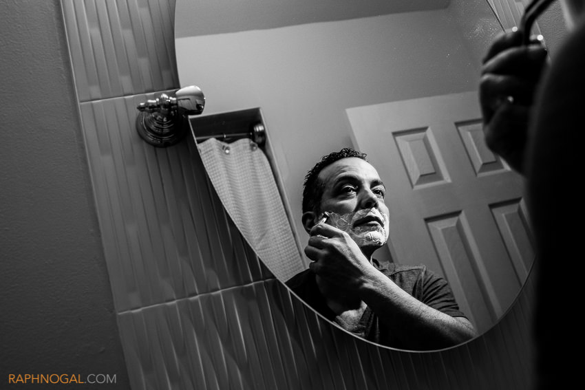 1-groom shaving in bathroom mirror