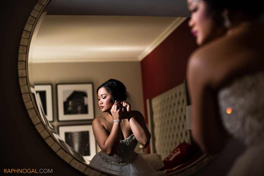 8-bride putting on earings in mirror