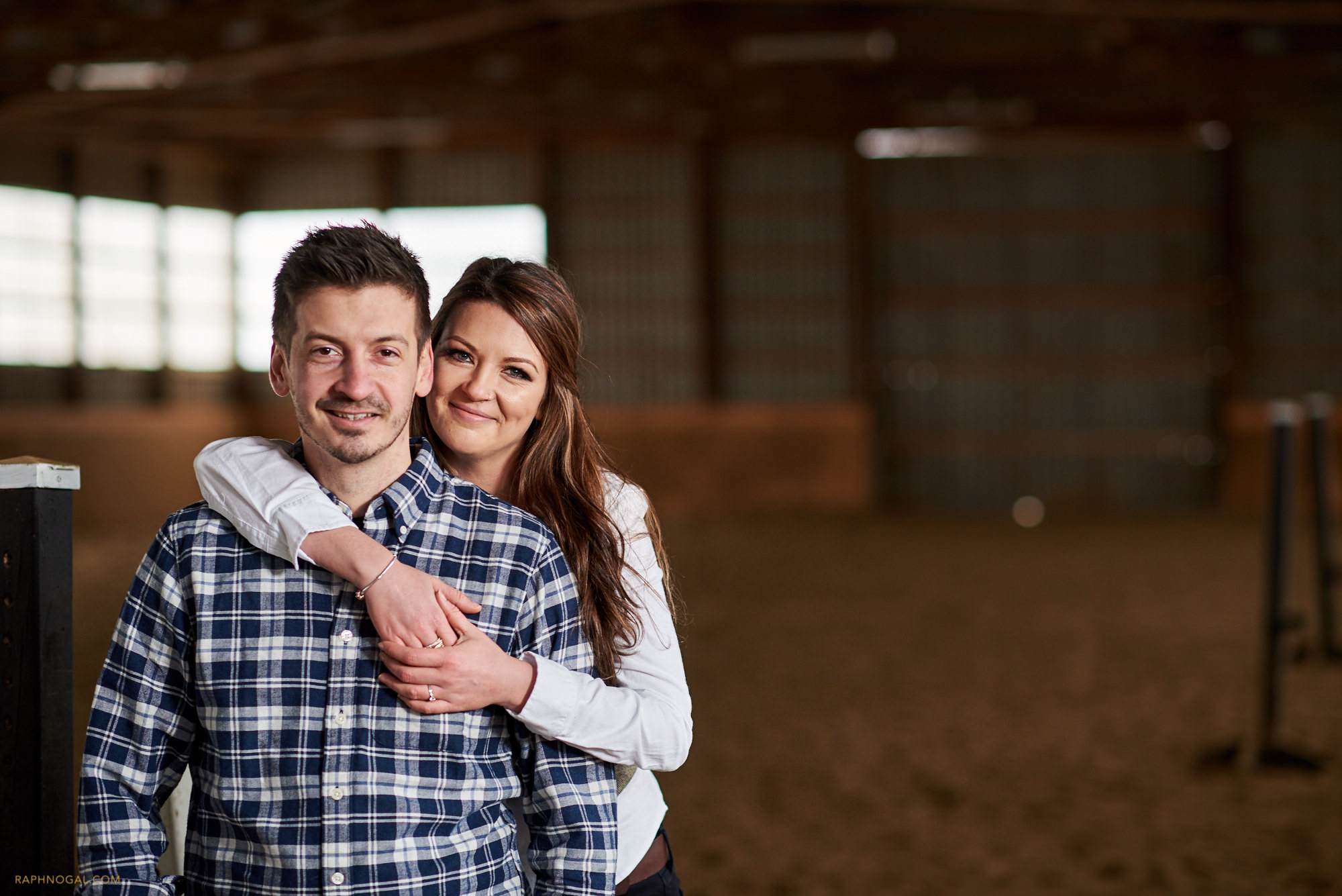 Couple hugging at Stonewood Equestrian during engagement photos