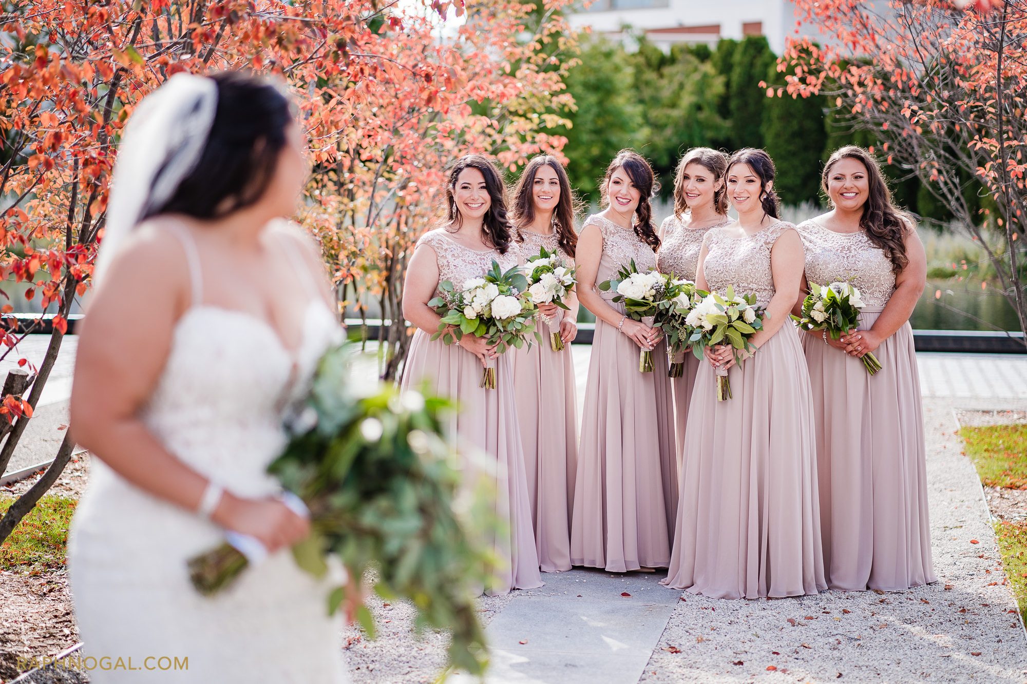 Bridesmaid smiling at Bride and she turn to them