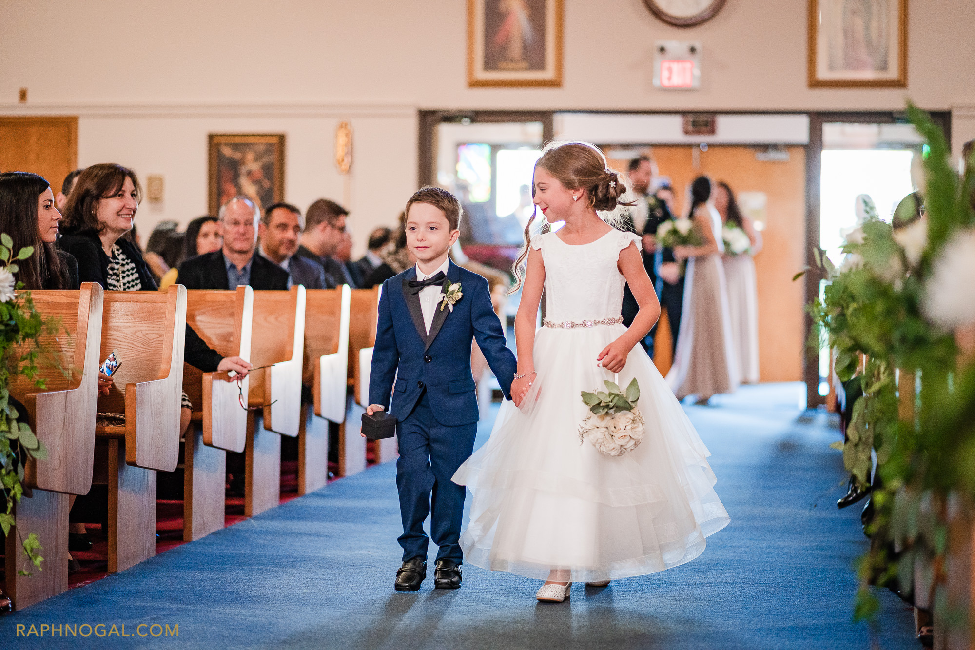 Ringboy and flowergirl walking down the isle